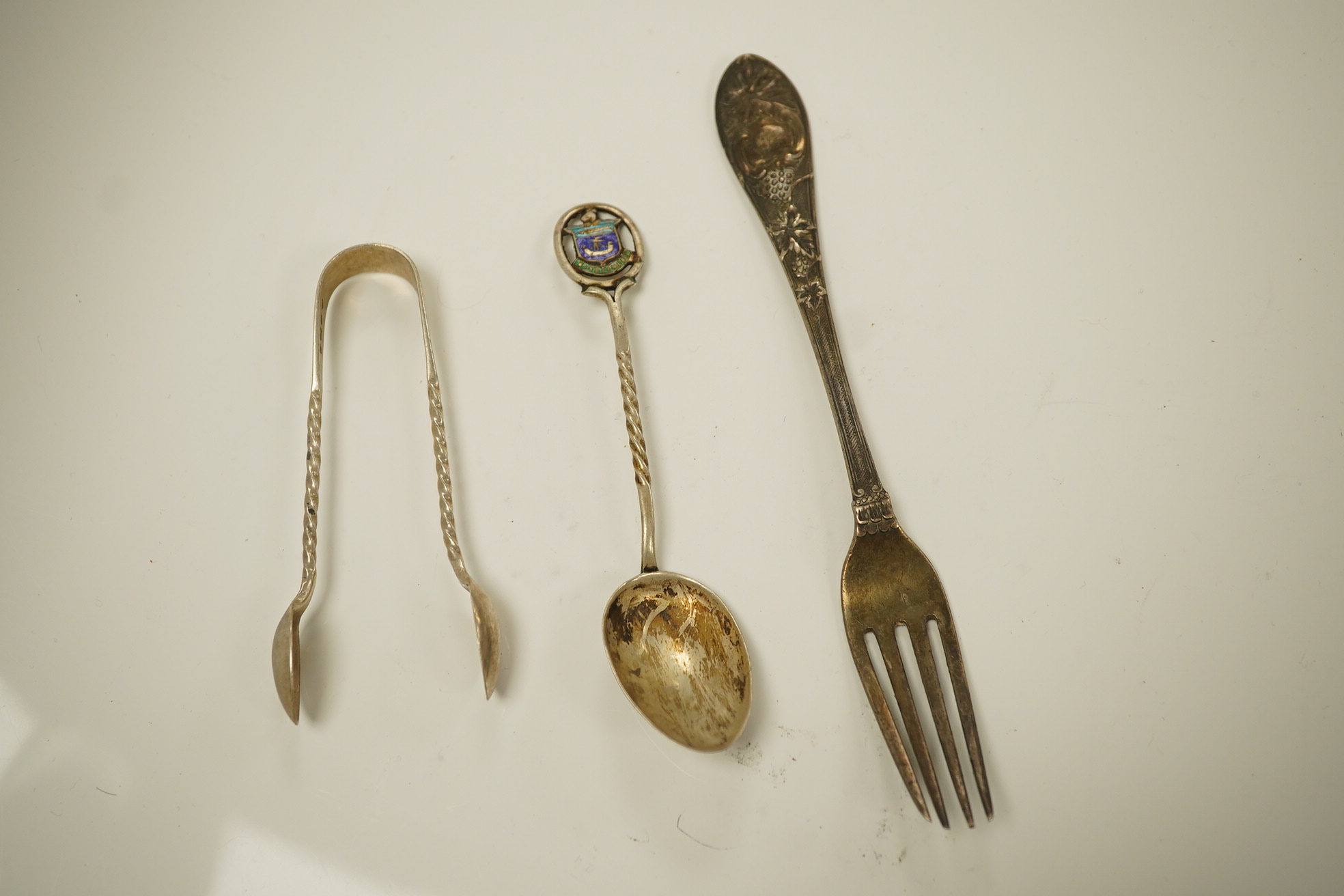 Twenty three items of mainly 19trh century silver fiddle pattern flatware, various dates and makers and a small group of assorted silver and white metal flatware, including Tiffany spoon, 39.8oz. Condition - poor to fair